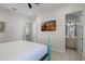 Bedroom with a teal bed frame and en-suite bathroom at 3075 Key Lime Loop, Kissimmee, FL 34747