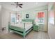 Light and airy bedroom with a teal bed frame and ample natural light at 3075 Key Lime Loop, Kissimmee, FL 34747