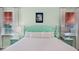 Bedroom with teal bed frame, nightstands, and coastal artwork at 3075 Key Lime Loop, Kissimmee, FL 34747
