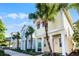 Row of colorful houses, including a yellow house with orange accents and palm trees at 3075 Key Lime Loop, Kissimmee, FL 34747