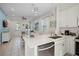 Open concept kitchen with island, stainless steel appliances, white cabinets at 3075 Key Lime Loop, Kissimmee, FL 34747