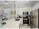 Well-equipped kitchen, stainless steel appliances, white cabinets at 3075 Key Lime Loop, Kissimmee, FL 34747