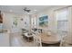 Open living and dining area with coastal decor, a sofa, and a large artwork at 3075 Key Lime Loop, Kissimmee, FL 34747