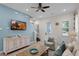 Bright living room featuring comfortable seating, a large TV, and stylish decor at 3075 Key Lime Loop, Kissimmee, FL 34747