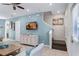 Living room with stairs to the second floor, a TV, and a light blue wall at 3075 Key Lime Loop, Kissimmee, FL 34747