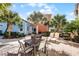 Private patio with table and chairs, plus lounge chairs at 3075 Key Lime Loop, Kissimmee, FL 34747