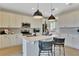 Modern kitchen with island and black pendant lights at 3740 Deer Ridge Dr, Mount Dora, FL 32757