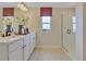 Elegant bathroom with double vanity and a frameless shower at 3740 Deer Ridge Dr, Mount Dora, FL 32757