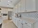 Spacious kitchen with white cabinets, quartz countertops, and stylish backsplash at 3740 Deer Ridge Dr, Mount Dora, FL 32757