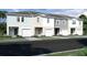 New townhouses with various exterior colors and two-car garages at 437 Madison Dr, Davenport, FL 33837
