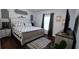 Primary bedroom with a king-size bed and a large TV at 468 Andalusia Loop, Davenport, FL 33837
