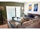 Living room with comfy seating and access to the backyard at 468 Andalusia Loop, Davenport, FL 33837