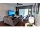 Living room with large TV and access to backyard at 468 Andalusia Loop, Davenport, FL 33837