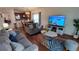 Spacious living room featuring comfortable seating and a large TV at 468 Andalusia Loop, Davenport, FL 33837