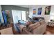 Relaxing living room with gray sofas, stylish artwork, and patio access at 468 Andalusia Loop, Davenport, FL 33837