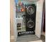 Stackable washer and dryer in a well-organized laundry room with storage shelves at 5140 Conroy Rd # 38, Orlando, FL 32811
