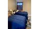 Well-lit bedroom with two twin beds and ample floor space at 5140 Conroy Rd # 38, Orlando, FL 32811