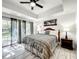 Bright bedroom with king bed and sliding glass doors to patio at 7510 Seven Eagles Way # 7510, Reunion, FL 34747
