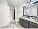 Bathroom with granite countertop, dark cabinets, and shower/tub combo at 7510 Seven Eagles Way # 7510, Reunion, FL 34747