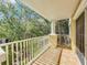 Private balcony overlooking lush green trees and a courtyard at 7510 Seven Eagles Way # 7510, Reunion, FL 34747