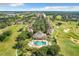 Aerial view of community pool, clubhouse, and golf course at 7510 Seven Eagles Way # 7510, Reunion, FL 34747