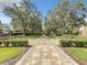 Walkway through a beautifully landscaped community with mature trees at 7510 Seven Eagles Way # 7510, Reunion, FL 34747