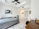 Main bedroom featuring a plush bed, a ceiling fan, and a view to the en-suite bathroom at 7510 Seven Eagles Way # 7510, Reunion, FL 34747
