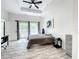 Main bedroom with private balcony access, a ceiling fan, and plenty of natural light at 7510 Seven Eagles Way # 7510, Reunion, FL 34747