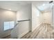 Upstairs hallway with wood-look floors and access to bedrooms at 7510 Seven Eagles Way # 7510, Reunion, FL 34747