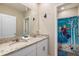 ' bathroom with double sinks, granite countertop, and Frozen-themed decor at 7635 Oakmoss Loop, Davenport, FL 33837