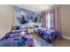 Twin bedroom with Frozen-themed bedding and mural at 7635 Oakmoss Loop, Davenport, FL 33837