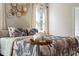 Bedroom with tropical bedding and neutral decor at 7635 Oakmoss Loop, Davenport, FL 33837