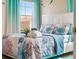 Charming bedroom with ocean-themed bedding and bright windows at 7635 Oakmoss Loop, Davenport, FL 33837