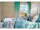 Bright bedroom with ocean-themed bedding and bright windows at 7635 Oakmoss Loop, Davenport, FL 33837