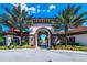 Gated community entrance with arch and landscaping at 7635 Oakmoss Loop, Davenport, FL 33837