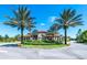 Gated community entrance with arched entryway and palm trees at 7635 Oakmoss Loop, Davenport, FL 33837