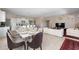 Open concept dining area with seating for six, adjacent to kitchen at 7635 Oakmoss Loop, Davenport, FL 33837