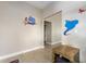 ' hallway featuring Aladdin-themed wall art and small table at 7635 Oakmoss Loop, Davenport, FL 33837