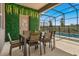 Covered lanai with dining area, lush greenery wall, and view of the pool at 7635 Oakmoss Loop, Davenport, FL 33837