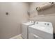 Laundry room with Whirlpool washer and dryer, and overhead shelving at 7635 Oakmoss Loop, Davenport, FL 33837