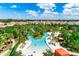 Relaxing lazy river with lounge chairs and lush landscaping at 7635 Oakmoss Loop, Davenport, FL 33837