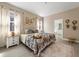 Spacious main bedroom with ensuite bathroom and calming decor at 7635 Oakmoss Loop, Davenport, FL 33837
