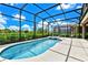 Relaxing kidney-shaped pool with a screened enclosure at 7635 Oakmoss Loop, Davenport, FL 33837