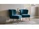 Elegant sitting area with teal velvet chairs and gold accents at 7635 Oakmoss Loop, Davenport, FL 33837