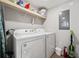 In-unit laundry with Whirlpool washer and dryer, storage shelves, and cleaning supplies at 8404 Crystal Cove Loop, Kissimmee, FL 34747