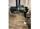 Dining area with glass table, black chairs, and wood-look flooring at 106 Orchid Ct, Kissimmee, FL 34759