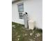 Exterior view of home water softener and salt tank at 106 Orchid Ct, Kissimmee, FL 34759