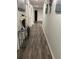 Long hallway with wood-look flooring and access to other rooms at 106 Orchid Ct, Kissimmee, FL 34759