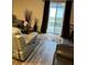 Living area with gray couches, wood-look floors, and sliding glass doors at 106 Orchid Ct, Kissimmee, FL 34759