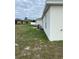 Side yard with grassy area and patio furniture at 106 Orchid Ct, Kissimmee, FL 34759